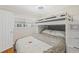 Bright bedroom showcases a white bunk bed with built-in storage and a window at 6016 Hibiscus Dr, Bradenton, FL 34207