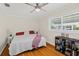 Bedroom with hardwood flooring, ceiling fan, and natural light from the window at 6016 Hibiscus Dr, Bradenton, FL 34207