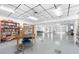 Spacious common area with large table, chairs, bookshelves, and tv at 6016 Hibiscus Dr, Bradenton, FL 34207