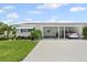 Charming single-story home featuring a covered carport and well-maintained landscaping at 6016 Hibiscus Dr, Bradenton, FL 34207