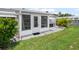 Exterior view showing a tiled patio, white exterior, and well-maintained lawn at 6016 Hibiscus Dr, Bradenton, FL 34207