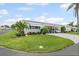 Charming single-story home with a well-maintained lawn and lush landscaping, showcasing curb appeal at 6016 Hibiscus Dr, Bradenton, FL 34207