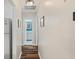 Hallway view leading to a bathroom with light blue accent wall and white cabinets at 6016 Hibiscus Dr, Bradenton, FL 34207