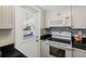 Bright kitchen featuring white appliances and cabinets, and dark countertops at 6016 Hibiscus Dr, Bradenton, FL 34207
