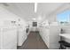 Clean, well-lit laundry room with multiple washers and dryers for residents' use at 6016 Hibiscus Dr, Bradenton, FL 34207