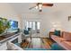 Open-concept living room with wood floors, a ceiling fan, and comfortable seating at 6016 Hibiscus Dr, Bradenton, FL 34207