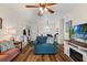 Cozy living room with hardwood floors, ceiling fan, and comfortable seating at 6016 Hibiscus Dr, Bradenton, FL 34207