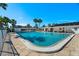 Community pool surrounded by palm trees and a white fence at 6016 Hibiscus Dr, Bradenton, FL 34207