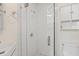Modern bathroom shower with glass door and white tiles, a sleek and functional design at 6016 Hibiscus Dr, Bradenton, FL 34207