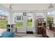 Bright sunroom with many windows, bookshelves, light walls, and hardwood-style flooring at 6016 Hibiscus Dr, Bradenton, FL 34207