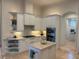 Bright kitchen featuring white cabinets, a center island with a marble countertop, and stainless steel appliances at 624 Mourning Dove Dr, Sarasota, FL 34236