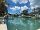 Scenic view of the waterfront with boats docked, lush greenery, and clear blue skies at 624 Mourning Dove Dr, Sarasota, FL 34236