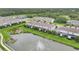 Aerial view featuring multiple townhomes with serene water views and manicured lawns at 6454 Baytown Dr, Sarasota, FL 34240
