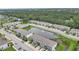 An aerial view of townhomes surrounding a scenic pond with lush landscaping at 6454 Baytown Dr, Sarasota, FL 34240