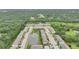 Aerial view of townhomes with well-maintained landscaping, pond, and community pool at 6454 Baytown Dr, Sarasota, FL 34240