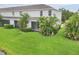 Lush backyard with green lawn and tropical landscaping, perfect for outdoor living at 6454 Baytown Dr, Sarasota, FL 34240