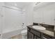 Bathroom with a dark granite vanity, and tiled tub and shower at 6454 Baytown Dr, Sarasota, FL 34240