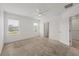Spacious bedroom with plush carpet, windows letting in natural light, and a doorway to another room at 6454 Baytown Dr, Sarasota, FL 34240