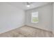 Bright bedroom featuring neutral carpet, a ceiling fan, and a window providing natural light at 6454 Baytown Dr, Sarasota, FL 34240