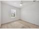 Well-lit bedroom with a large window, plush carpet and ceiling fan at 6454 Baytown Dr, Sarasota, FL 34240