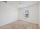 Bright bedroom featuring neutral carpet, a ceiling fan, and a window providing natural light at 6454 Baytown Dr, Sarasota, FL 34240