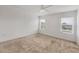 Large bedroom with neutral carpet and natural light from two windows at 6454 Baytown Dr, Sarasota, FL 34240