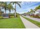 Baytown Square community entrance with lush landscaping, sidewalk and street access at 6454 Baytown Dr, Sarasota, FL 34240