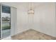 Corner dining area features an elegant light fixture and sliding door access to the outside at 6454 Baytown Dr, Sarasota, FL 34240