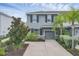 Front exterior of gray two-story home featuring a garage and mature landscaping at 6454 Baytown Dr, Sarasota, FL 34240