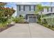 Charming two-story home with a gray exterior, black shutters, and a two-car garage at 6454 Baytown Dr, Sarasota, FL 34240