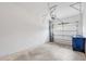 A two-car garage features white-painted walls and concrete flooring at 6454 Baytown Dr, Sarasota, FL 34240