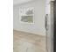 Kitchen area featuring tile floors, stainless steel refrigerator, and window at 6454 Baytown Dr, Sarasota, FL 34240