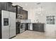 Open kitchen with dark cabinets, stainless steel appliances, and seamless flow into the living area at 6454 Baytown Dr, Sarasota, FL 34240