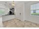 An eat in kitchen with black granite countertops, tile flooring, and modern lighting at 6454 Baytown Dr, Sarasota, FL 34240