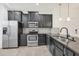 Modern kitchen featuring stainless steel appliances, dark cabinetry and light tile floors at 6454 Baytown Dr, Sarasota, FL 34240