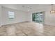 Spacious living room with neutral paint, tile flooring, lots of natural light, and sliding glass doors at 6454 Baytown Dr, Sarasota, FL 34240