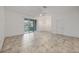 Spacious living area with tile flooring and sliding glass doors offering views of the backyard at 6454 Baytown Dr, Sarasota, FL 34240