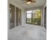 The screened patio has a ceiling fan, tile flooring, and an outdoor space at 6454 Baytown Dr, Sarasota, FL 34240
