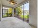 A screened patio features a ceiling fan and views of the yard and waterway at 6454 Baytown Dr, Sarasota, FL 34240