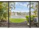 Serene view from the screened lanai overlooking the water and fountain at 6454 Baytown Dr, Sarasota, FL 34240