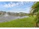 Townhome community with water fountain feature and lush grass that leads up to the pond at 6454 Baytown Dr, Sarasota, FL 34240