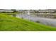 View of a community pond with a fountain and lush green grass around the perimeter at 6454 Baytown Dr, Sarasota, FL 34240
