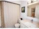 Well-lit bathroom featuring a shower with patterned curtain, white vanity, and a large mirror at 6504 Heritage Ln # 99, Bradenton, FL 34209