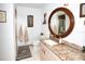 Cozy bathroom with a granite-topped vanity, round mirror, and shower in an enclosed stall at 6504 Heritage Ln # 99, Bradenton, FL 34209