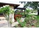 Charming entrance with colorful flowers, lush greenery, and a welcoming pathway to the front door at 6504 Heritage Ln # 99, Bradenton, FL 34209