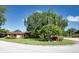 Charming single-story home with lush landscaping and mature trees on a sunny day at 6504 Heritage Ln # 99, Bradenton, FL 34209