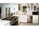 Bright kitchen with stainless steel appliances, white cabinetry, and a view to the yard through a french door at 6504 Heritage Ln # 99, Bradenton, FL 34209
