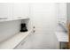 Bright laundry room with upper and lower cabinets, countertop space, and a washer-dryer set at 6504 Heritage Ln # 99, Bradenton, FL 34209