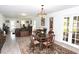 Open-concept living and dining area with elegant furnishings, tile flooring, and French doors to the backyard at 6504 Heritage Ln # 99, Bradenton, FL 34209