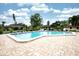Sparkling community pool with ample seating, well-maintained landscaping, and clear blue water at 6504 Heritage Ln # 99, Bradenton, FL 34209